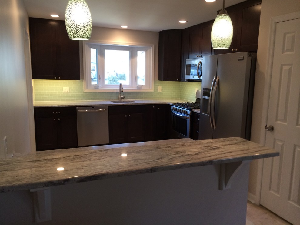 Example of a small trendy l-shaped porcelain tile eat-in kitchen design in Philadelphia with an undermount sink, shaker cabinets, dark wood cabinets, granite countertops, green backsplash, glass tile backsplash and stainless steel appliances