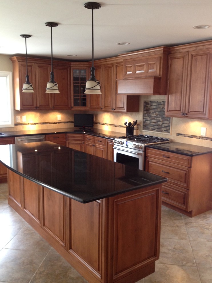 Example of a mid-sized arts and crafts l-shaped travertine floor eat-in kitchen design in Newark with an undermount sink, raised-panel cabinets, medium tone wood cabinets, quartz countertops, beige backsplash, ceramic backsplash, stainless steel appliances and an island