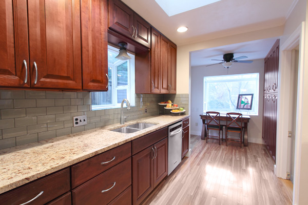 grey backsplash with cherry cabinets
