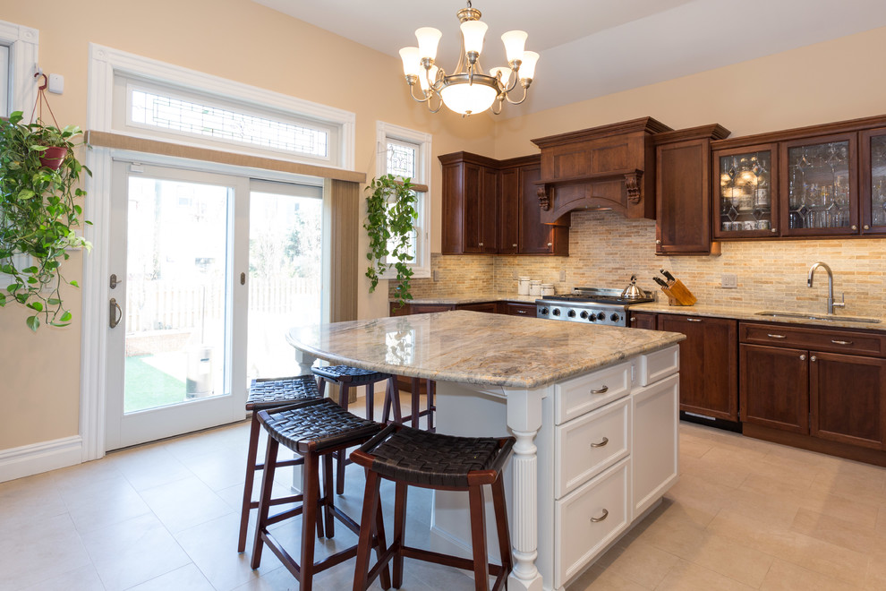 Large elegant u-shaped ceramic tile and beige floor enclosed kitchen photo in New York with an undermount sink, recessed-panel cabinets, medium tone wood cabinets, quartzite countertops, stainless steel appliances, an island, multicolored backsplash and mosaic tile backsplash