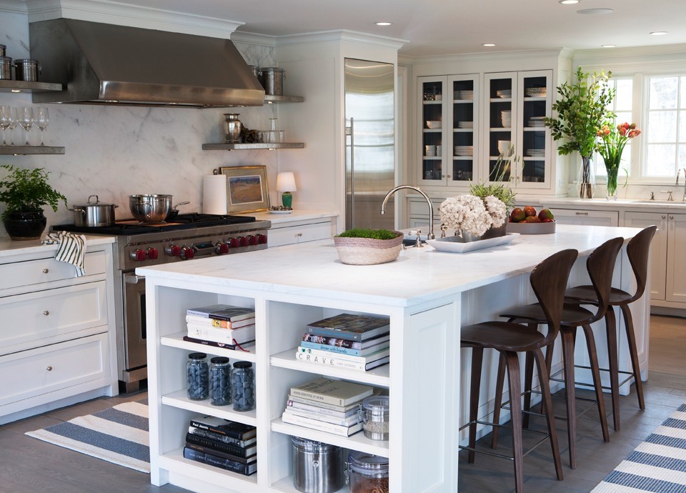 Inspiration for a large transitional u-shaped dark wood floor and brown floor eat-in kitchen remodel in New York with recessed-panel cabinets, white cabinets, marble countertops, white backsplash, stone slab backsplash, stainless steel appliances, an island and an undermount sink