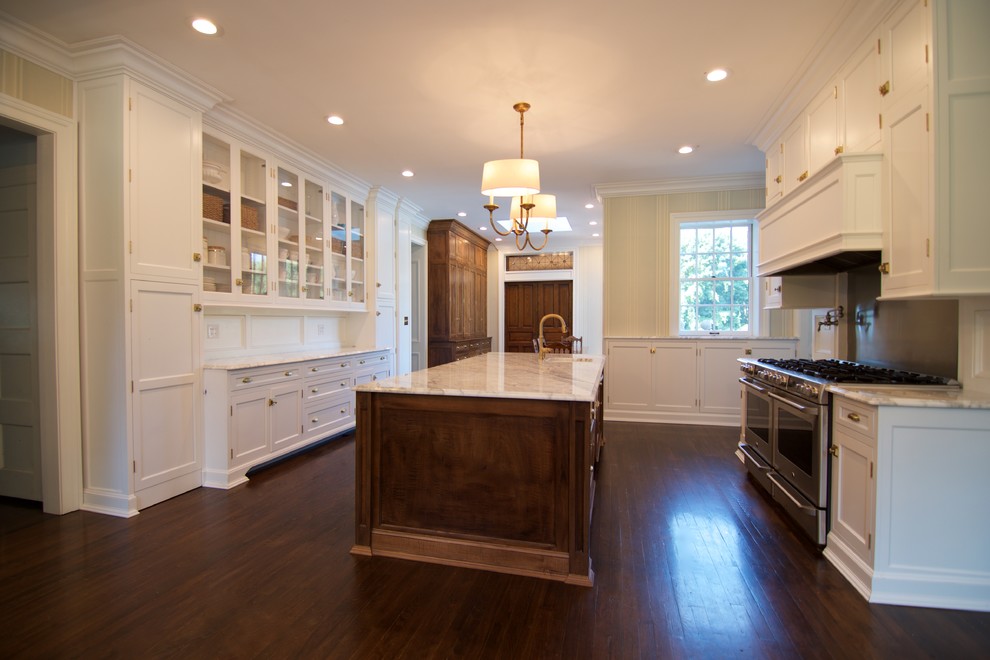 Large elegant dark wood floor eat-in kitchen photo in Other with a farmhouse sink, recessed-panel cabinets, white cabinets, marble countertops, white backsplash, stainless steel appliances and an island