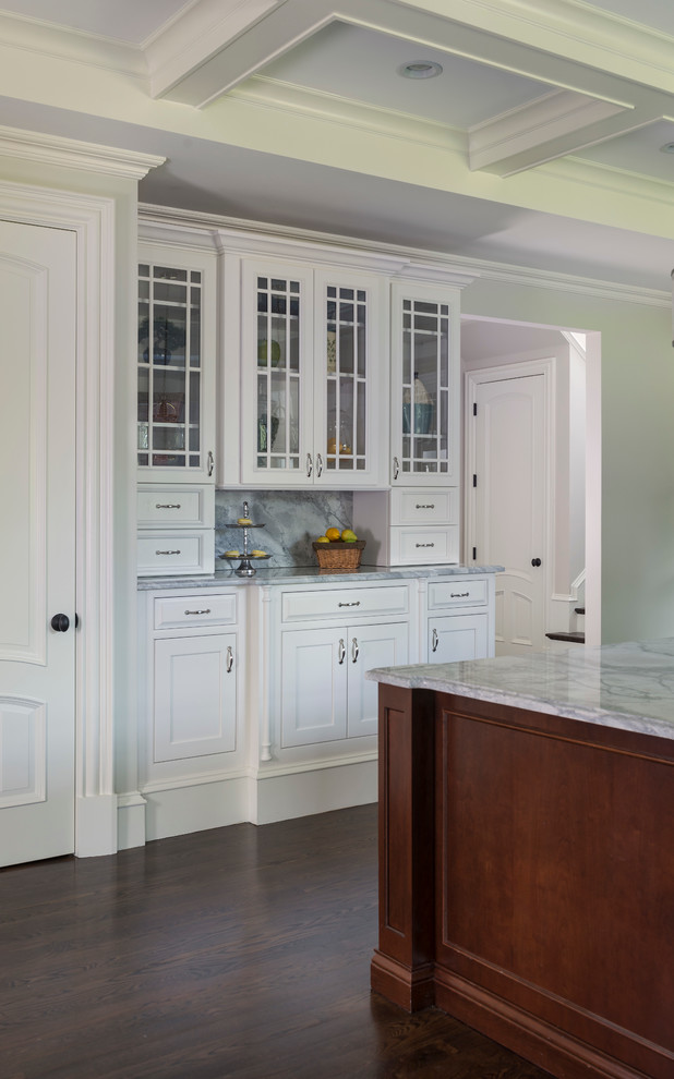 Example of a large classic l-shaped dark wood floor eat-in kitchen design in Boston with a farmhouse sink, recessed-panel cabinets, white cabinets, granite countertops, white backsplash, ceramic backsplash, stainless steel appliances and an island