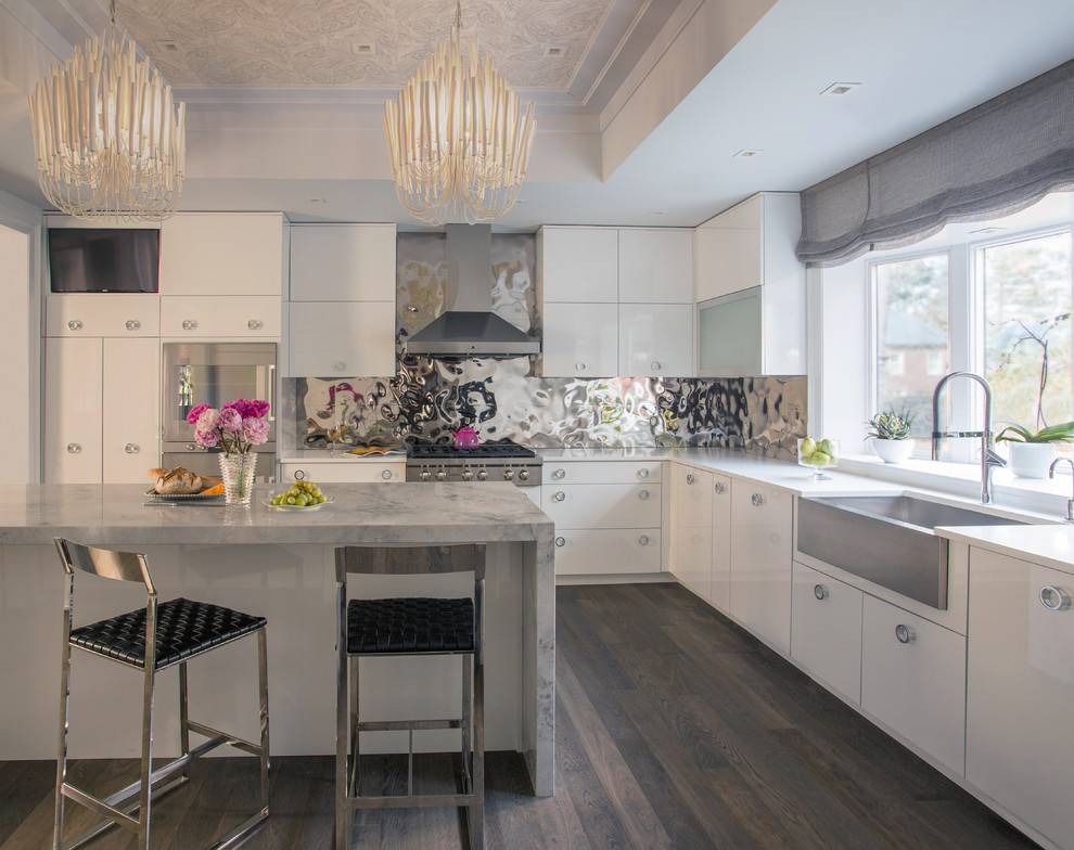 Inspiration for an expansive contemporary grey and white u-shaped kitchen in Boston with a belfast sink, flat-panel cabinets, white cabinets, marble worktops, metallic splashback, metal splashback, stainless steel appliances, an island and dark hardwood flooring.