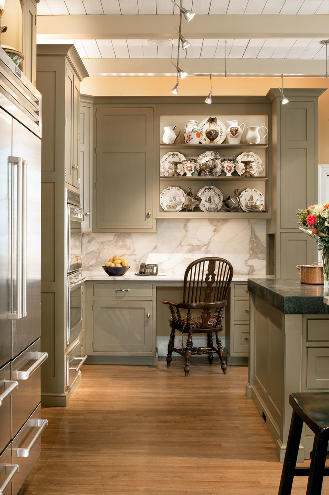 Inspiration for a timeless medium tone wood floor and brown floor kitchen remodel in DC Metro with an undermount sink, beaded inset cabinets, green cabinets, marble countertops, white backsplash, stone slab backsplash, stainless steel appliances and an island