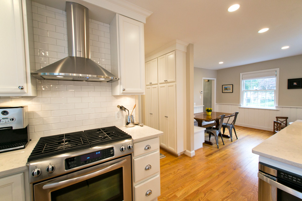 Example of a classic eat-in kitchen design in DC Metro with an undermount sink and raised-panel cabinets