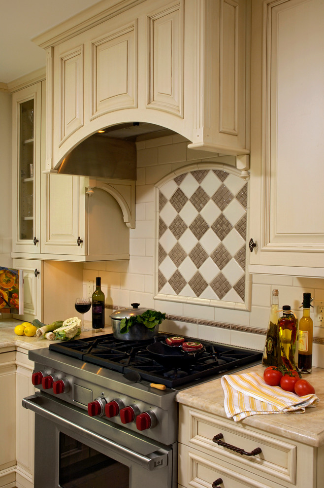 Example of a mid-sized classic u-shaped cement tile floor and beige floor eat-in kitchen design in DC Metro with an undermount sink, beaded inset cabinets, white cabinets, granite countertops, multicolored backsplash, mosaic tile backsplash, stainless steel appliances and an island