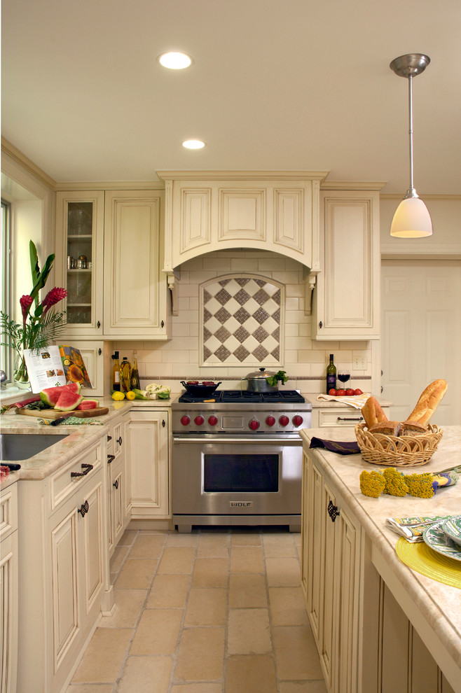 Eat-in kitchen - mid-sized traditional u-shaped cement tile floor and beige floor eat-in kitchen idea in DC Metro with an undermount sink, beaded inset cabinets, white cabinets, granite countertops, multicolored backsplash, mosaic tile backsplash, stainless steel appliances and an island