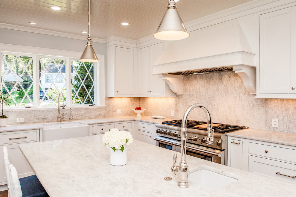 Large elegant u-shaped medium tone wood floor eat-in kitchen photo in DC Metro with a farmhouse sink, recessed-panel cabinets, white cabinets, granite countertops, white backsplash, stone slab backsplash, stainless steel appliances and an island