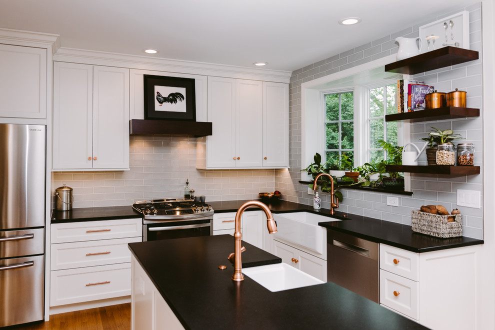 Eat-in kitchen - mid-sized transitional single-wall dark wood floor and brown floor eat-in kitchen idea in DC Metro with a farmhouse sink, shaker cabinets, white cabinets, soapstone countertops, white appliances, an island and black countertops