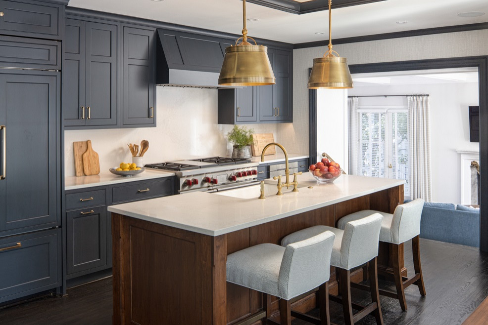 ワシントンD.C.にあるラグジュアリーな中くらいなトランジショナルスタイルのおしゃれなキッチン (シングルシンク、落し込みパネル扉のキャビネット、青いキャビネット、クオーツストーンカウンター、白いキッチンパネル、石スラブのキッチンパネル、パネルと同色の調理設備、濃色無垢フローリング、茶色い床、白いキッチンカウンター) の写真
