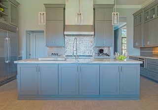 front view of a modern blue kitchen with pots and accessories