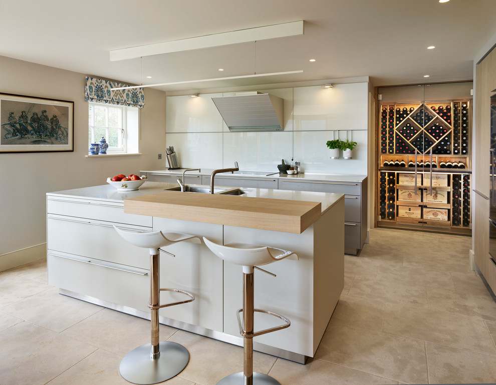 Esempio di una cucina design con ante lisce, ante grigie, paraspruzzi bianco, elettrodomestici in acciaio inossidabile e pavimento beige
