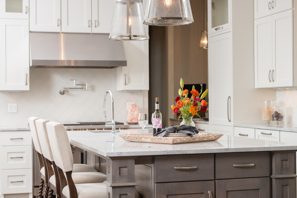 Large transitional dark wood floor eat-in kitchen photo in Chicago with a single-bowl sink, shaker cabinets, white cabinets, marble countertops, white backsplash, glass tile backsplash, paneled appliances and an island