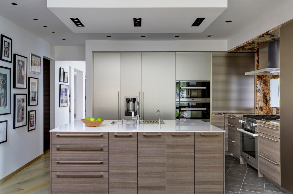 Inspiration for a contemporary kitchen in Chicago with a submerged sink, flat-panel cabinets, dark wood cabinets, stainless steel appliances, an island, brown floors and white worktops.
