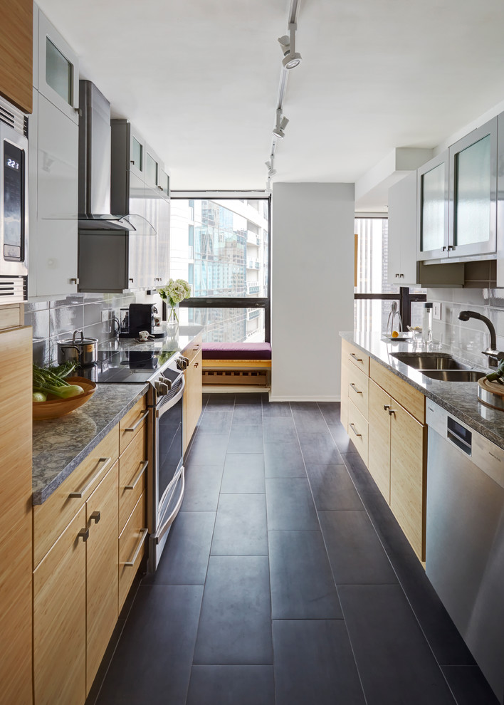 Enclosed kitchen - small modern galley porcelain tile enclosed kitchen idea in Chicago with a double-bowl sink, flat-panel cabinets, light wood cabinets, quartz countertops, gray backsplash, stainless steel appliances, a peninsula and porcelain backsplash