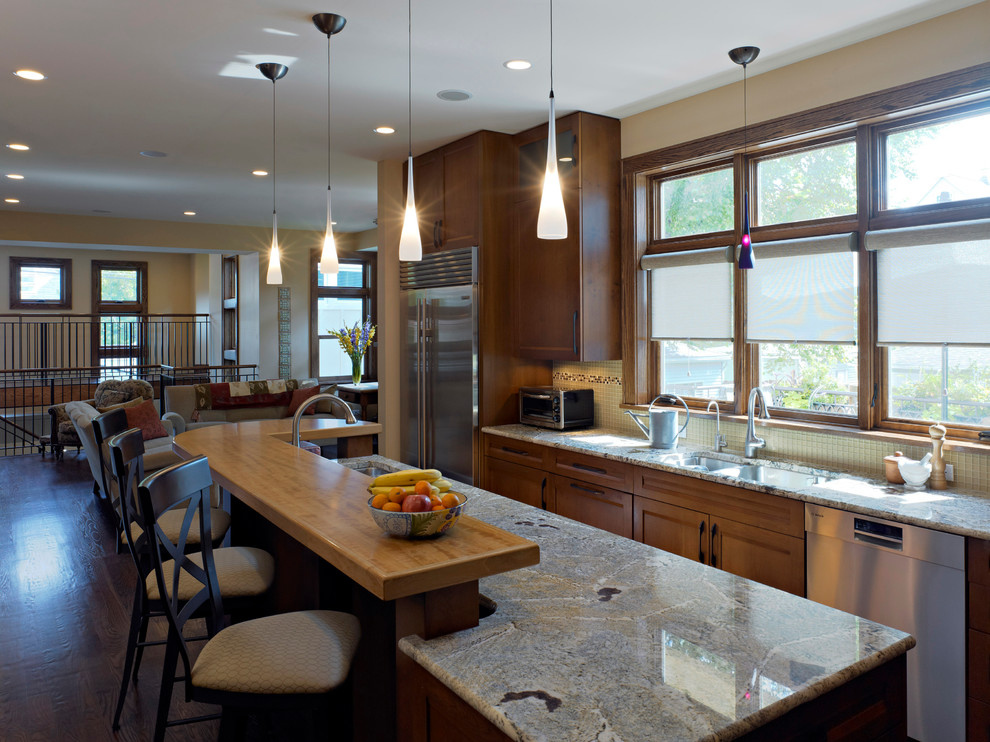 Large traditional l-shaped open plan kitchen in Chicago with medium wood cabinets, wood worktops, beige splashback, stainless steel appliances, a submerged sink, recessed-panel cabinets and dark hardwood flooring.