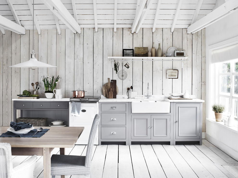 Design ideas for a medium sized rural grey and white single-wall kitchen/diner in London with a belfast sink, grey cabinets, grey floors, painted wood flooring, beaded cabinets, wood splashback, white appliances and no island.