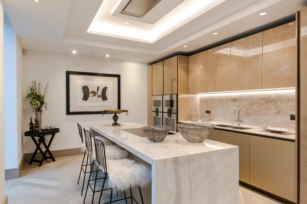 Inspiration for a contemporary single-wall enclosed kitchen in London with a double-bowl sink, flat-panel cabinets, beige cabinets, beige splashback, black appliances, light hardwood flooring, an island, beige floors and beige worktops.