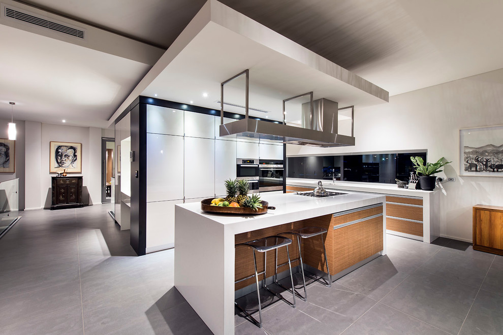 Design ideas for a large contemporary l-shaped kitchen pantry in Perth with a double-bowl sink, flat-panel cabinets, white cabinets, engineered stone countertops, white splashback, glass sheet splashback, black appliances, porcelain flooring and an island.