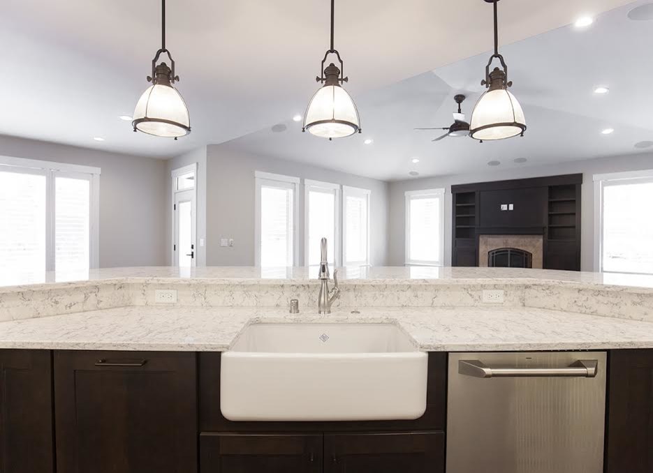 Large transitional medium tone wood floor eat-in kitchen photo in Other with an undermount sink, shaker cabinets, white cabinets, quartzite countertops, white backsplash, subway tile backsplash, stainless steel appliances and an island