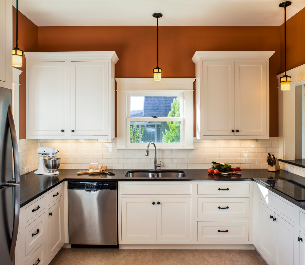 Example of a mid-sized arts and crafts u-shaped linoleum floor open concept kitchen design in Portland with an undermount sink, shaker cabinets, white cabinets, quartz countertops, white backsplash, subway tile backsplash, stainless steel appliances and a peninsula
