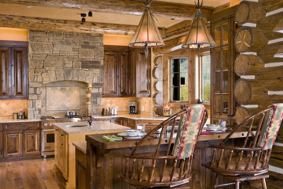 Foto di una cucina rustica con ante con bugna sagomata, ante in legno bruno e elettrodomestici in acciaio inossidabile