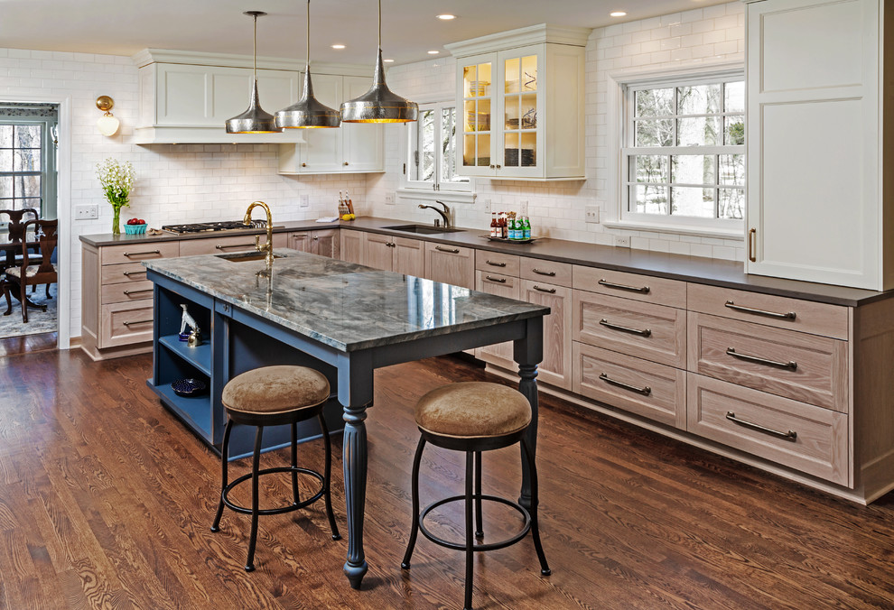 Kitchen - traditional l-shaped dark wood floor and brown floor kitchen idea in Milwaukee with an undermount sink, recessed-panel cabinets, medium tone wood cabinets, white backsplash, subway tile backsplash, an island and brown countertops
