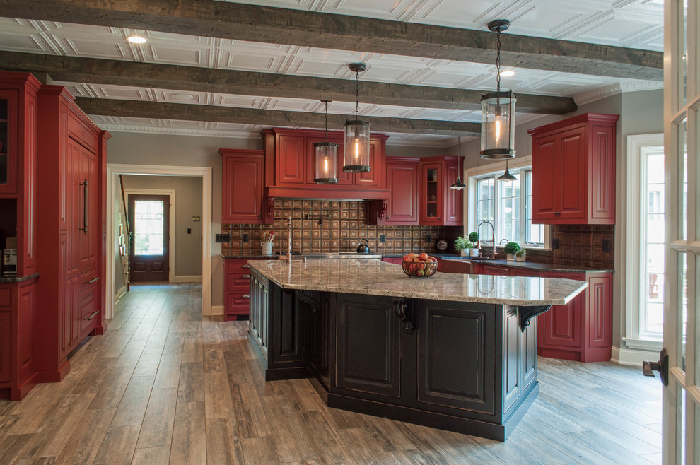 Large classic kitchen in Other with beaded cabinets, red cabinets, stainless steel appliances and an island.