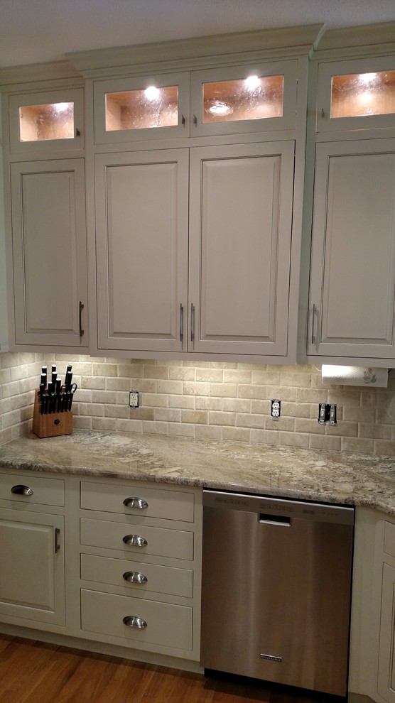 Inspiration for a transitional u-shaped kitchen remodel in Omaha with white cabinets, granite countertops and a peninsula