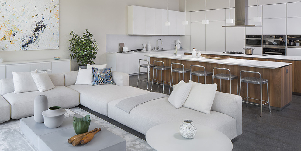 This is an example of a large contemporary l-shaped kitchen/diner in San Francisco with a built-in sink, white cabinets, stainless steel appliances and multiple islands.
