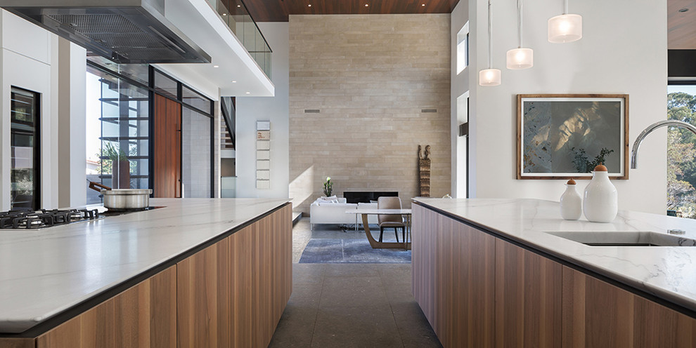 Inspiration for a large contemporary l-shaped eat-in kitchen remodel in San Francisco with a drop-in sink, white cabinets, stainless steel appliances and two islands