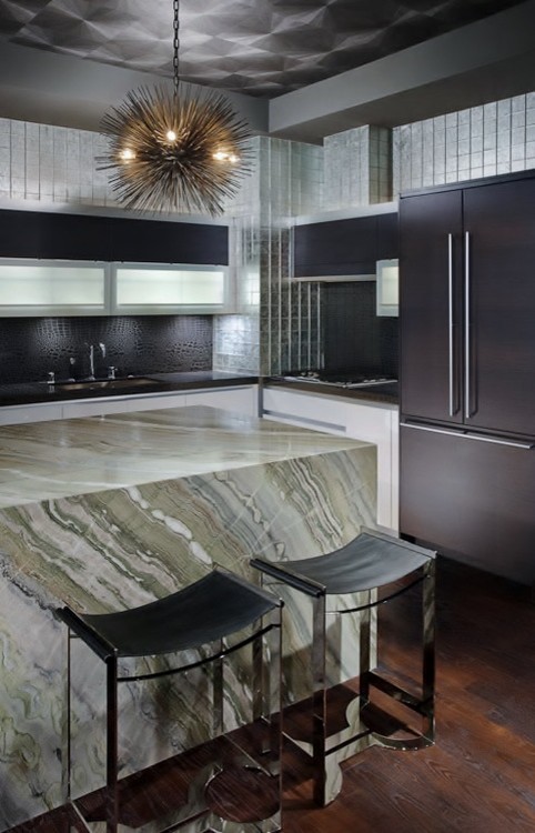Eat-in kitchen - contemporary u-shaped medium tone wood floor eat-in kitchen idea in Las Vegas with marble countertops, black backsplash, mosaic tile backsplash, paneled appliances and an island