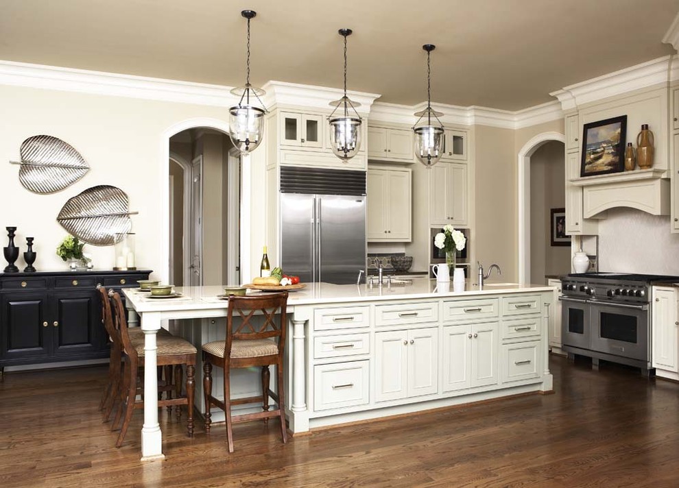 Eat-in kitchen - large contemporary u-shaped medium tone wood floor eat-in kitchen idea in Other with stainless steel appliances, shaker cabinets, beige cabinets, marble countertops, white backsplash, an island, an undermount sink and ceramic backsplash