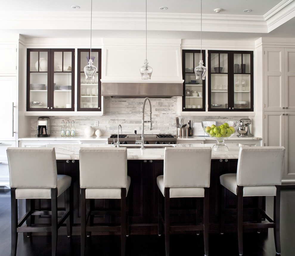 Example of a transitional galley kitchen design in Toronto with white backsplash, marble countertops, an undermount sink, white cabinets, glass-front cabinets, paneled appliances, marble backsplash and white countertops