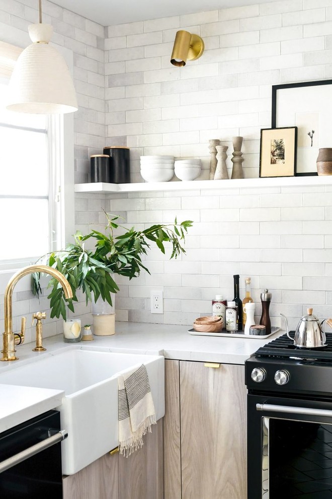 Inspiration for a small contemporary u-shaped enclosed kitchen in Salt Lake City with a belfast sink, flat-panel cabinets, grey cabinets, metro tiled splashback, black appliances and white floors.