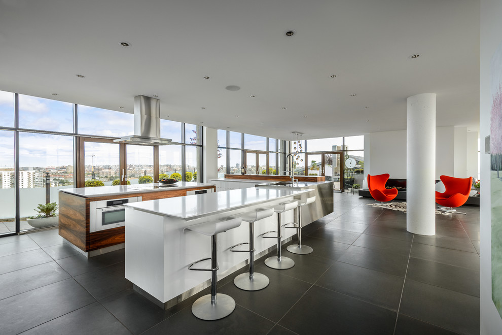 Свежая идея для дизайна: угловая кухня-гостиная в стиле модернизм с монолитной мойкой - отличное фото интерьера