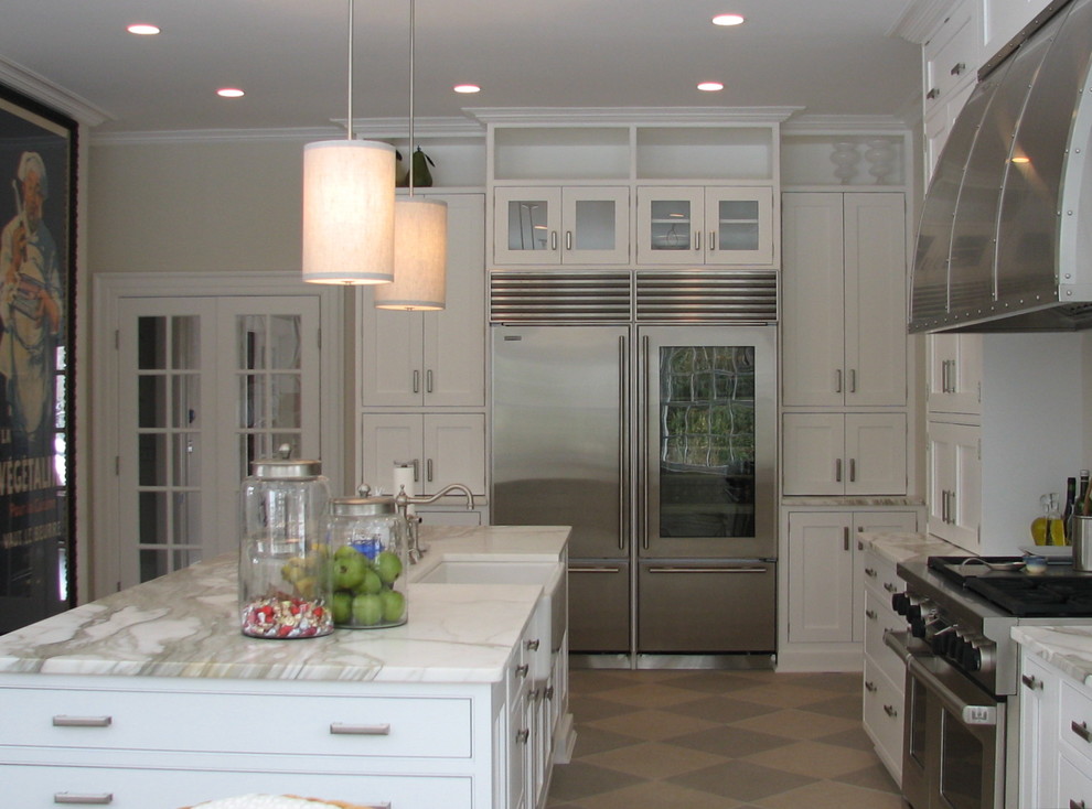 This is an example of a large classic u-shaped kitchen/diner in New York with flat-panel cabinets, white cabinets, marble worktops, an island, a belfast sink, stainless steel appliances and lino flooring.