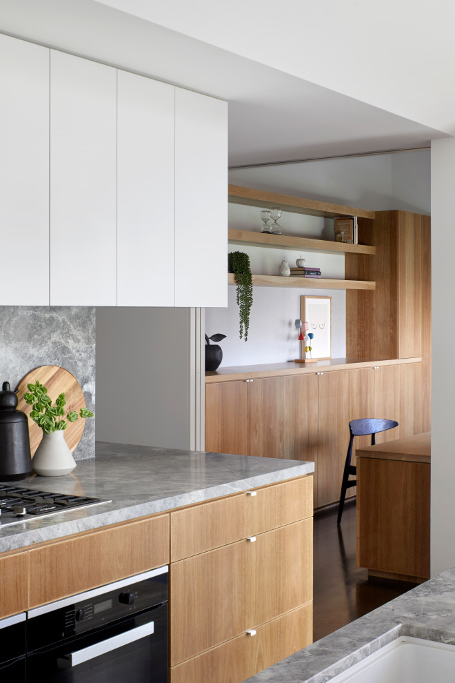 Eat-in kitchen - large contemporary single-wall dark wood floor and brown floor eat-in kitchen idea in Melbourne with an undermount sink, flat-panel cabinets, light wood cabinets, quartz countertops, gray backsplash, stainless steel appliances, an island and gray countertops