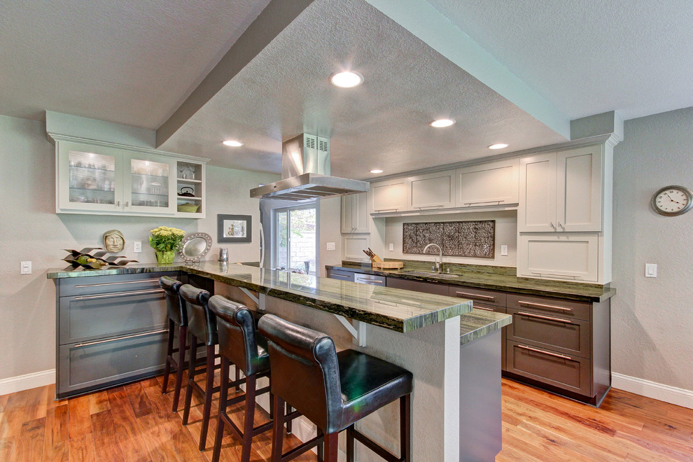 Example of a mid-sized trendy galley medium tone wood floor open concept kitchen design in Los Angeles with an undermount sink, shaker cabinets, gray cabinets, quartzite countertops, green backsplash, stone slab backsplash and stainless steel appliances