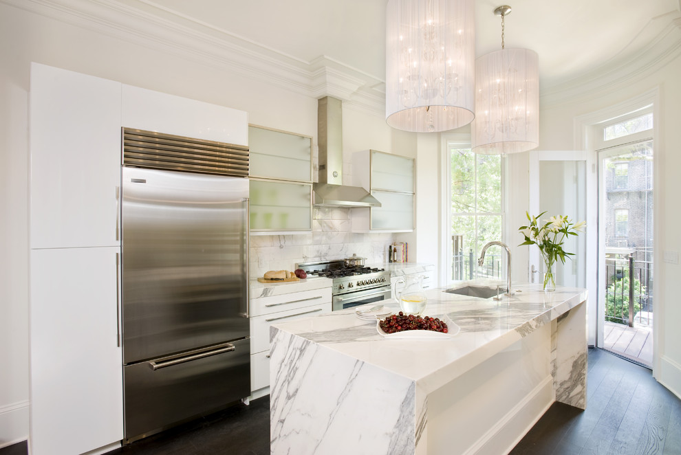Transitional galley kitchen photo in Boston with stainless steel appliances, a single-bowl sink, glass-front cabinets, white cabinets, marble countertops, white backsplash and marble backsplash
