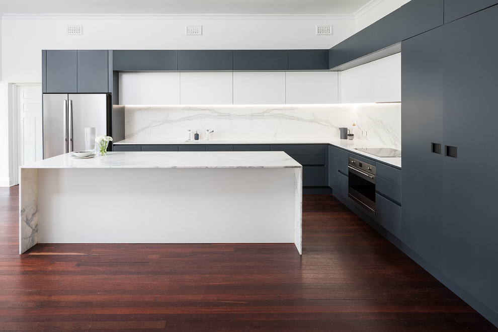 Example of a large trendy l-shaped dark wood floor open concept kitchen design in Perth with an undermount sink, gray cabinets, marble countertops, white backsplash, stainless steel appliances and an island