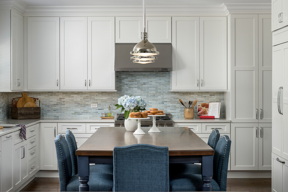 Immagine di un cucina con isola centrale classico con ante in stile shaker, ante bianche, paraspruzzi blu, elettrodomestici in acciaio inossidabile, parquet scuro e pavimento marrone