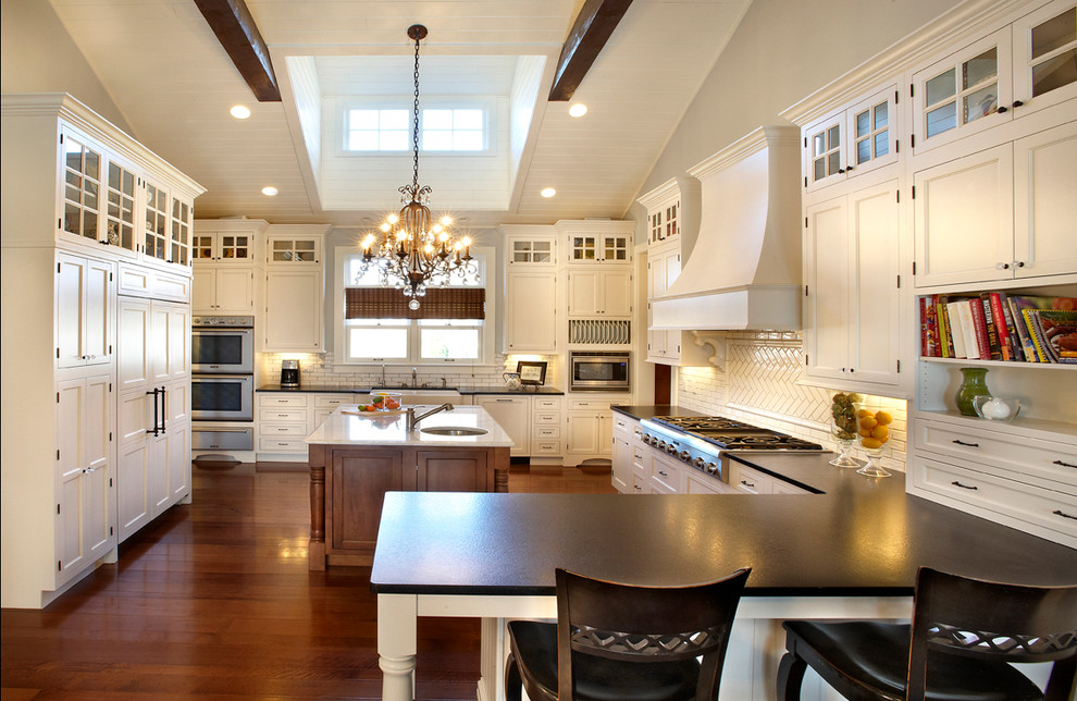 Example of a classic kitchen design in St Louis with an undermount sink, white cabinets, white backsplash, subway tile backsplash, paneled appliances and shaker cabinets