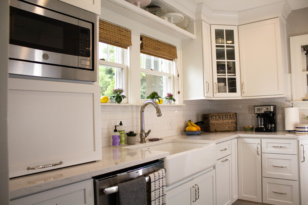 Foto på ett avskilt, litet lantligt vit l-kök, med en rustik diskho, öppna hyllor, vita skåp, bänkskiva i kvarts, vitt stänkskydd, stänkskydd i keramik, rostfria vitvaror, mellanmörkt trägolv och brunt golv