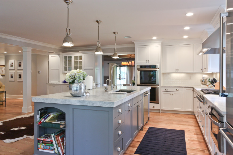 Inspiration for a timeless open concept kitchen remodel in Newark with stainless steel appliances, gray cabinets, recessed-panel cabinets, marble countertops and white backsplash