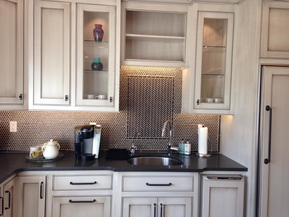 Example of a transitional kitchen design in Philadelphia with an undermount sink, beaded inset cabinets, distressed cabinets, quartz countertops, metallic backsplash, metal backsplash, paneled appliances and an island