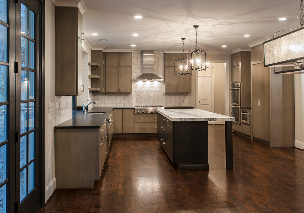 Inspiration for an expansive traditional u-shaped kitchen in Philadelphia with flat-panel cabinets, white splashback, ceramic splashback, dark hardwood flooring and an island.