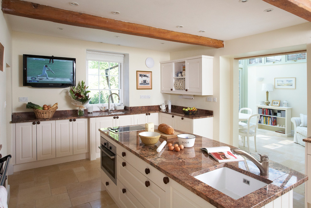 Inspiration for a rural kitchen/diner in Other with a submerged sink, raised-panel cabinets, white cabinets, granite worktops, stainless steel appliances, limestone flooring and an island.