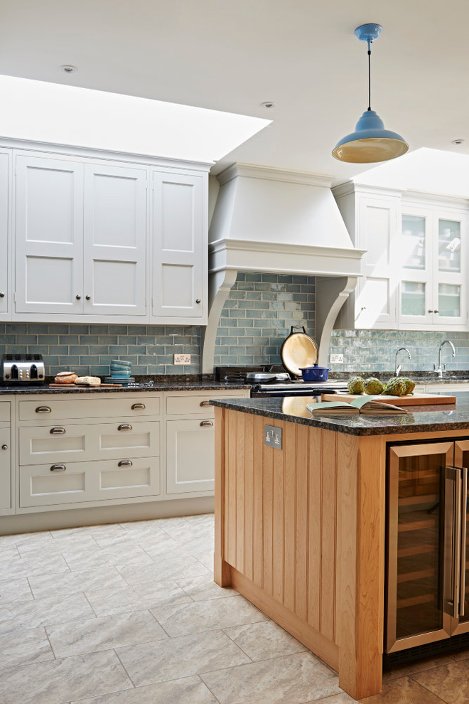 Inspiration for a medium sized rural grey and cream kitchen/diner in London with a belfast sink, shaker cabinets, granite worktops, blue splashback, ceramic splashback, stainless steel appliances and an island.